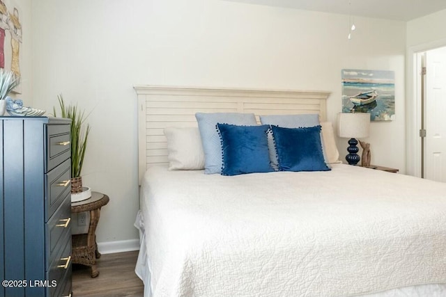 bedroom with wood finished floors and baseboards
