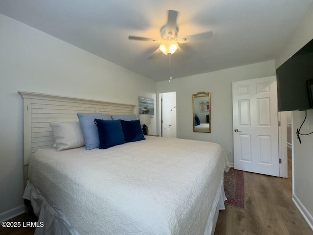 bedroom with wood finished floors, baseboards, and a ceiling fan