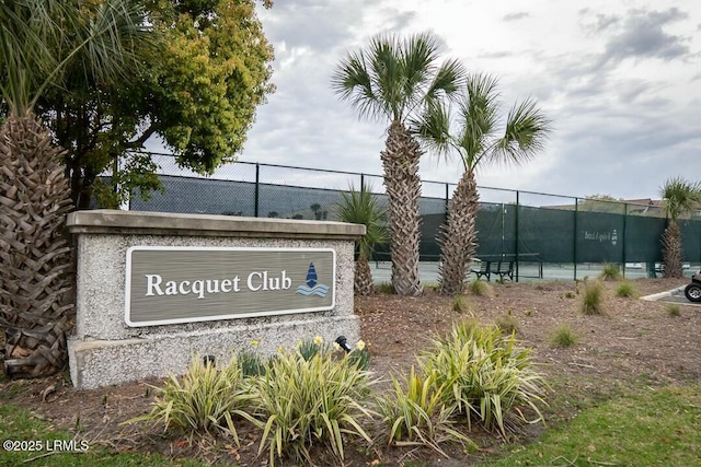 community / neighborhood sign featuring fence