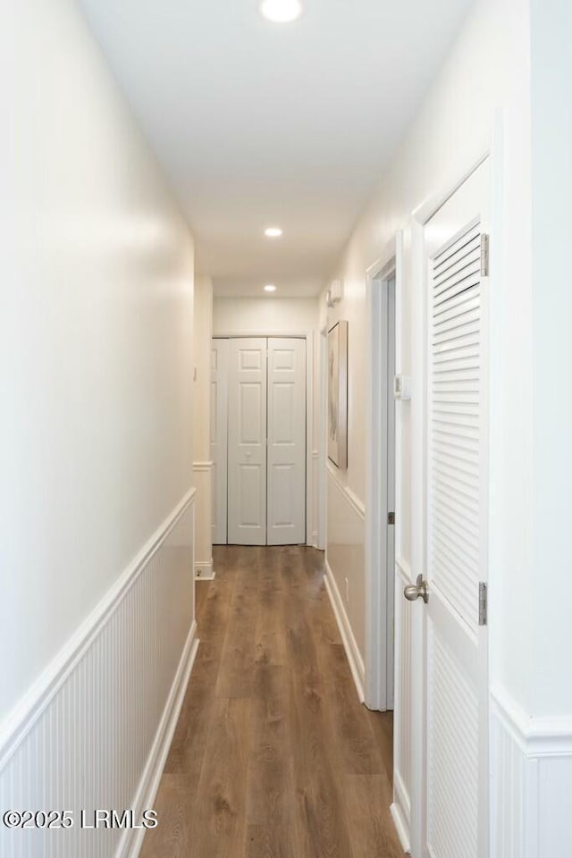 corridor with recessed lighting, wainscoting, and dark wood-style flooring