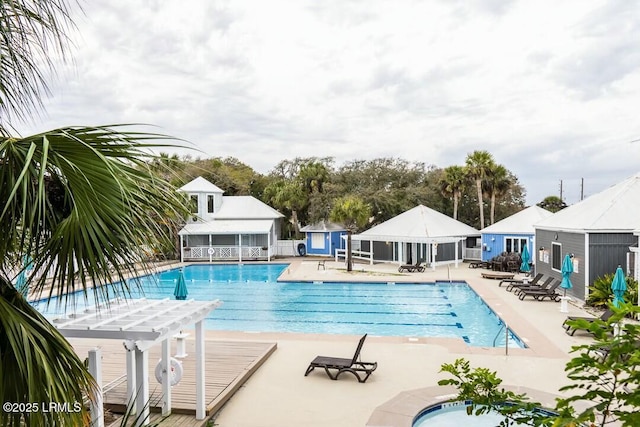 pool with a pergola, a gazebo, an outdoor structure, fence, and a patio