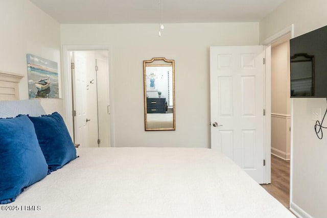 bedroom with wood finished floors