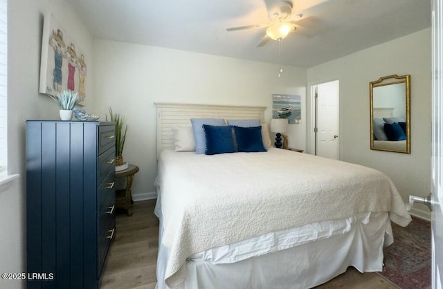 bedroom with baseboards, a ceiling fan, and wood finished floors