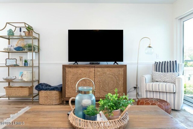 living room featuring wainscoting and wood finished floors