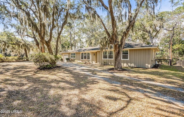 view of front of property with driveway and fence