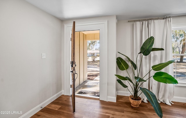 entrance foyer featuring baseboards and wood finished floors