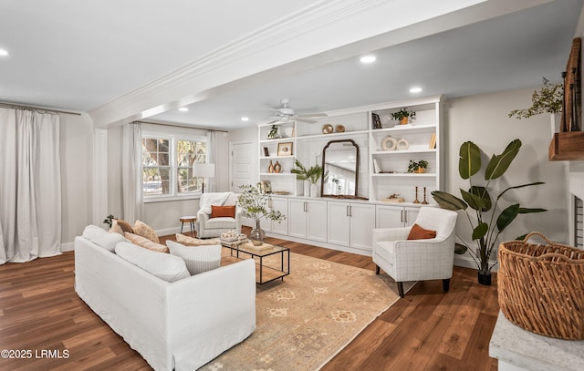 living area featuring ornamental molding, recessed lighting, dark wood finished floors, and baseboards