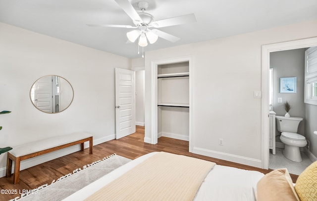 bedroom with a closet, baseboards, and wood finished floors