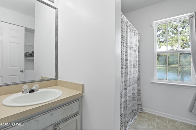 22 Sandy Pointe Dr, Bluffton, SC 29910 - bathroom featuring vanity, healthy amount of natural light, baseboards, and curtained shower