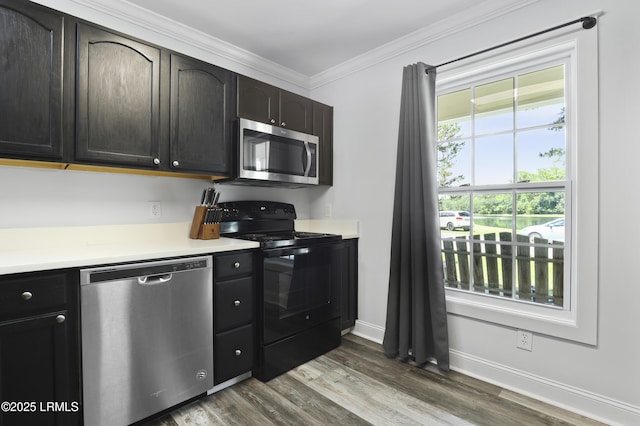 22 Sandy Pointe Dr, Bluffton, SC 29910 - kitchen featuring appliances with stainless steel finishes, dark wood-style floors, crown molding, light countertops, and baseboards