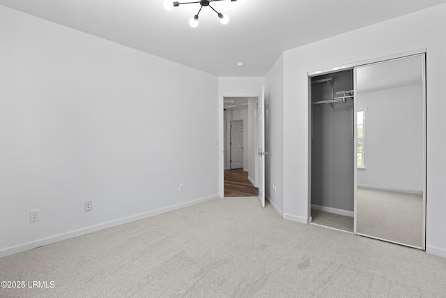 22 Sandy Pointe Dr, Bluffton, SC 29910 - unfurnished bedroom with carpet floors, baseboards, a closet, and a chandelier