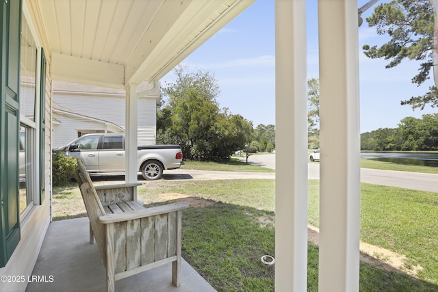 22 Sandy Pointe Dr, Bluffton, SC 29910 - covered porch with a yard, a water view, and driveway