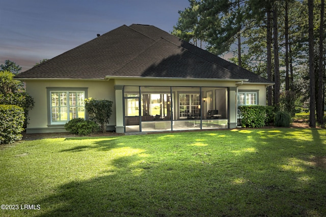 back house at dusk with a yard