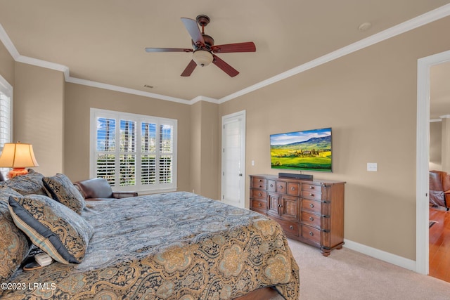 bedroom featuring crown molding, ceiling fan, and light colored carpet