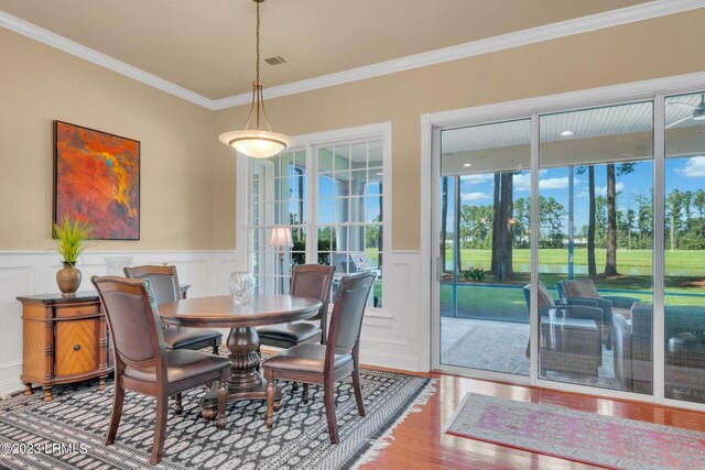 dining area with ornamental molding and wood-type flooring