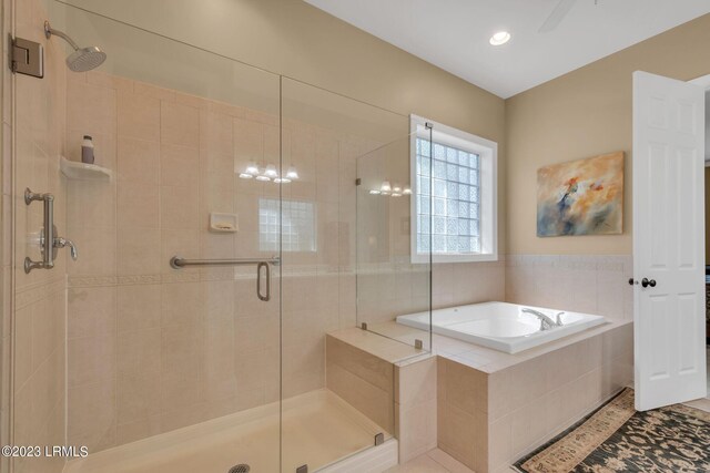 bathroom with separate shower and tub and tile patterned floors