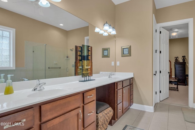 bathroom featuring ceiling fan, vanity, a shower with shower door, and tile patterned flooring