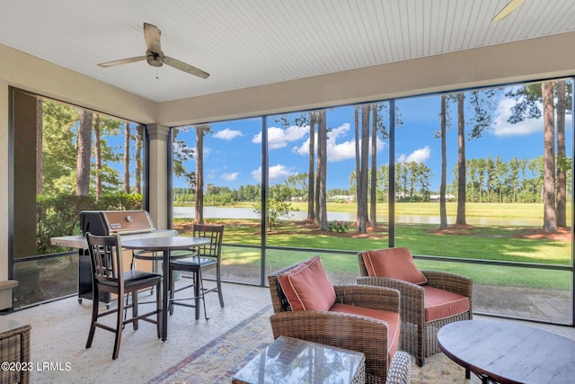 sunroom / solarium featuring ceiling fan