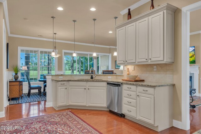 kitchen with sink, light wood-type flooring, dishwasher, white cabinets, and backsplash