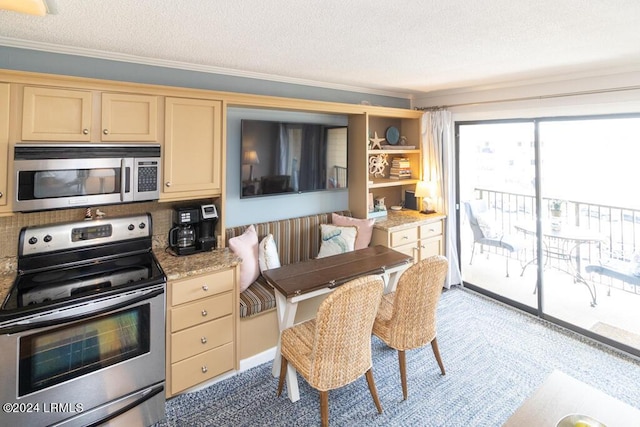 kitchen with stainless steel appliances, ornamental molding, light stone counters, and a textured ceiling