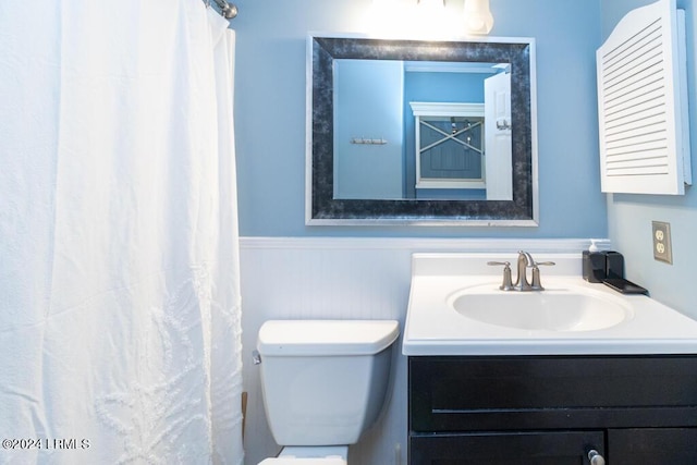 bathroom featuring vanity, a shower with curtain, and toilet