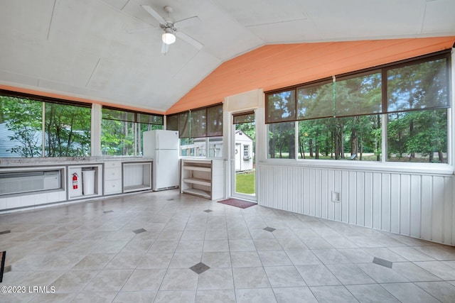 unfurnished sunroom featuring vaulted ceiling and a ceiling fan