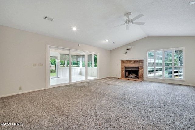 unfurnished living room featuring visible vents, a ceiling fan, lofted ceiling, carpet floors, and a fireplace