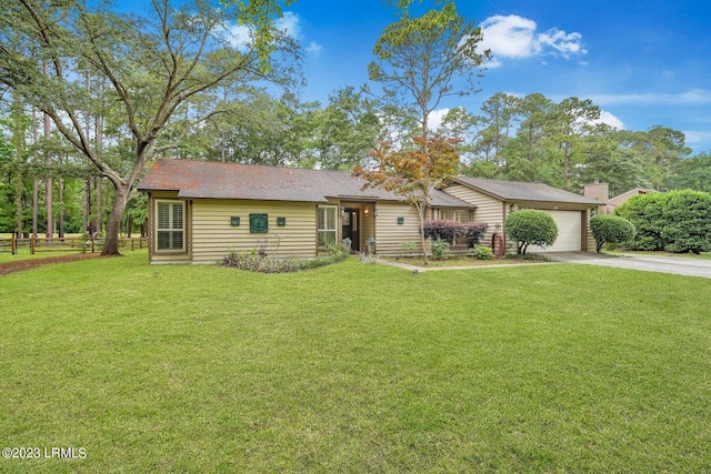 ranch-style home with a garage, driveway, a front lawn, and fence