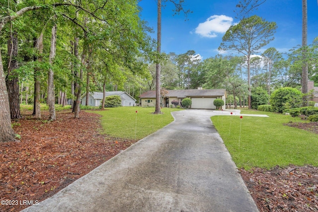 view of front facade with a garage, driveway, and a front lawn