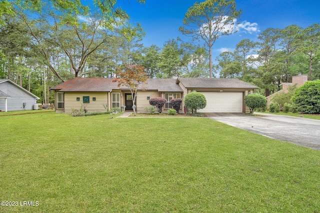 single story home with concrete driveway, a front lawn, and an attached garage