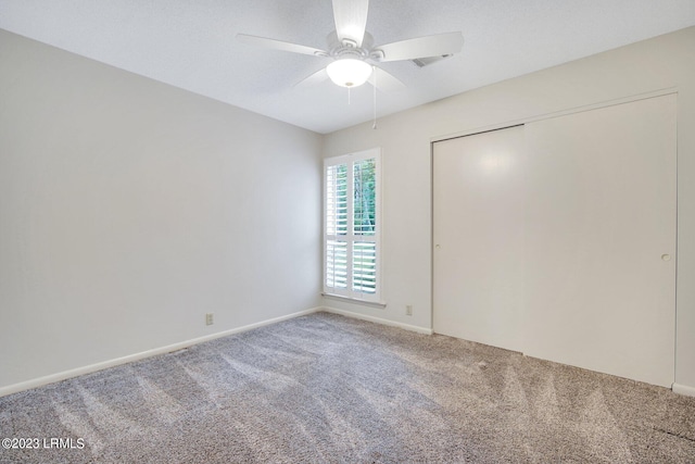 interior space featuring carpet floors, baseboards, and a ceiling fan