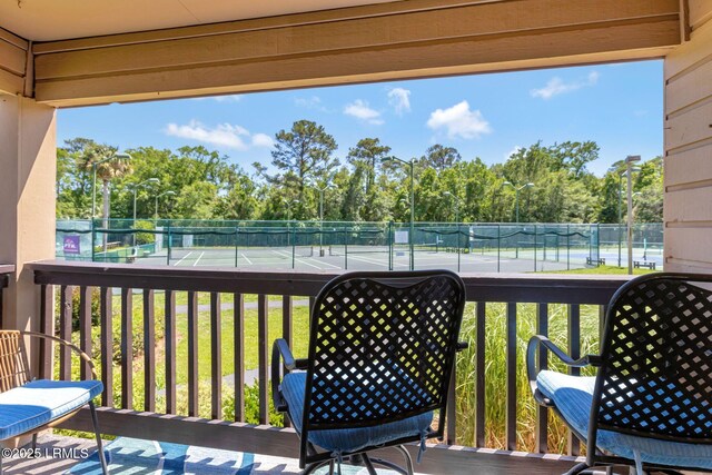 40 Folly Field Rd Unit G1, Hilton Head Island, SC 29928 - balcony featuring a tennis court and view of wooded area