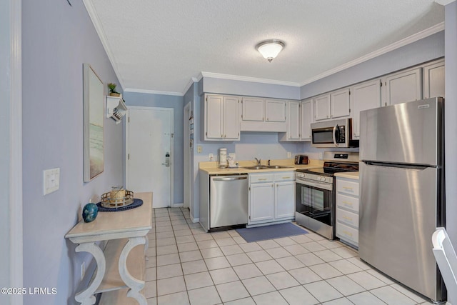 40 Folly Field Rd Unit G1, Hilton Head Island, SC 29928 - kitchen featuring stainless steel appliances, light countertops, a textured ceiling, light tile patterned flooring, and crown molding