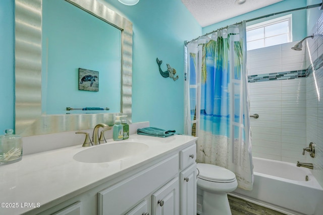 bathroom featuring toilet, shower / tub combo, a textured ceiling, vanity, and wood finished floors