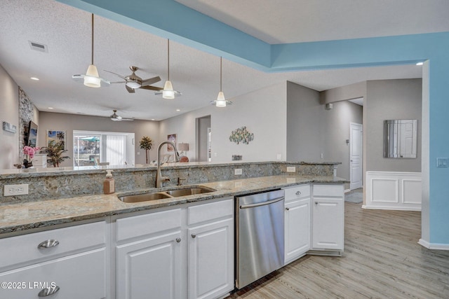 kitchen featuring white cabinets, dishwasher, and decorative light fixtures