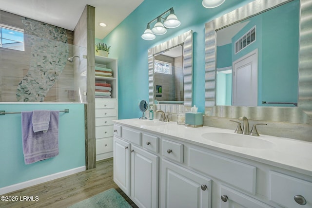 bathroom with a healthy amount of sunlight, a sink, and wood finished floors