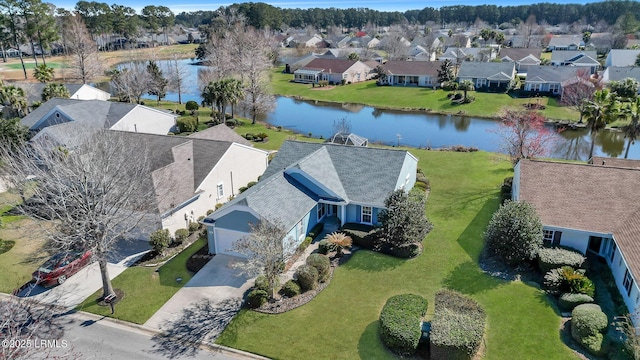 drone / aerial view featuring a residential view and a water view