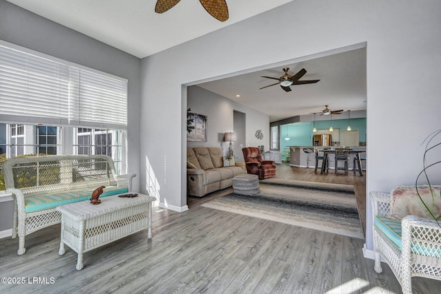 living area with light wood-style floors and baseboards