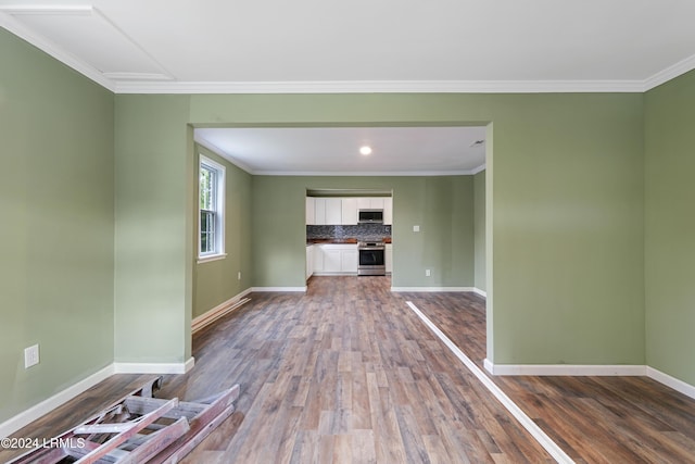 unfurnished living room with wood-type flooring and ornamental molding