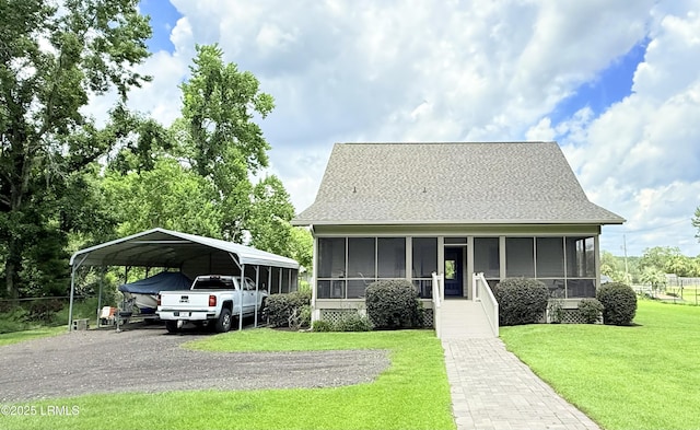 189 Deloss Point Rd, Ridgeland, SC 29936 - bungalow-style house with a sunroom, a detached carport, driveway, and a front yard
