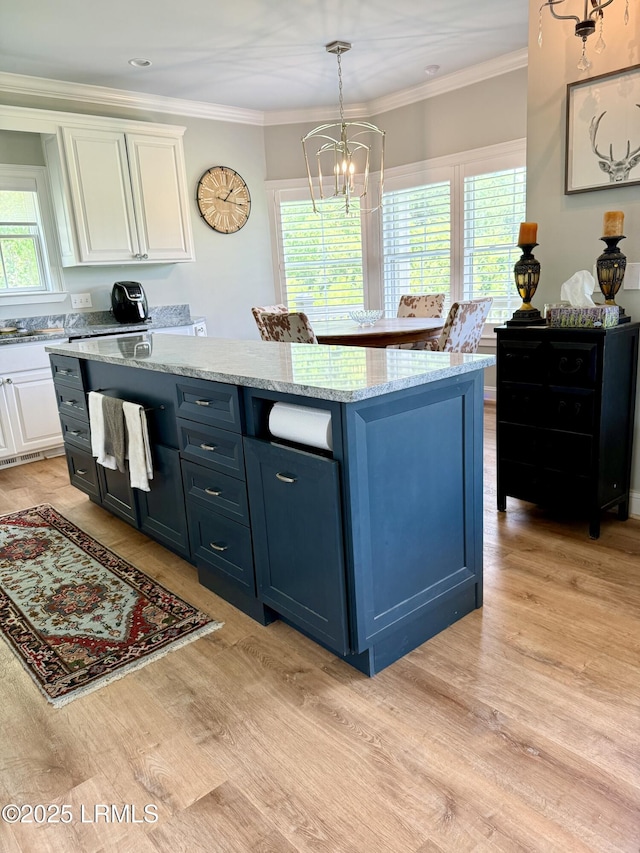 189 Deloss Point Rd, Ridgeland, SC 29936 - kitchen featuring white cabinets, light wood-style flooring, a chandelier, a center island, and healthy amount of natural light