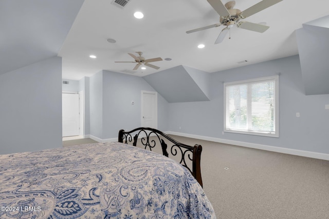 bedroom with ceiling fan, carpet floors, and vaulted ceiling