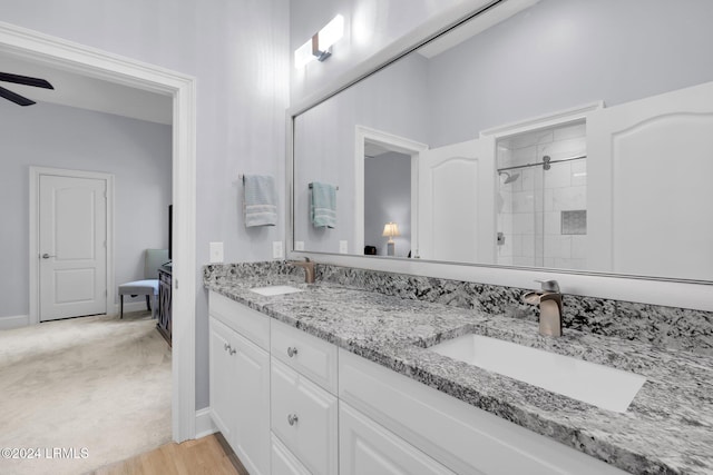 bathroom featuring vanity, a shower, and ceiling fan