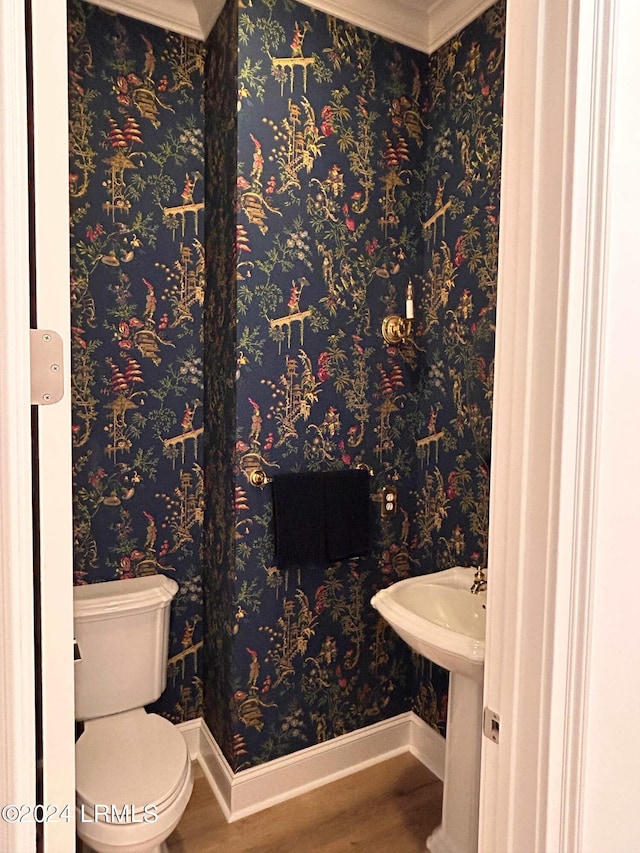 bathroom with ornamental molding, hardwood / wood-style floors, and toilet