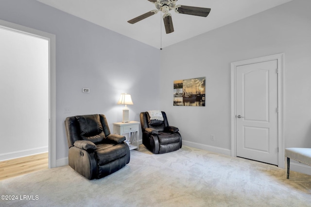 living area with ceiling fan and carpet flooring