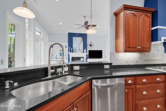 kitchen with hanging light fixtures, dishwasher, sink, and decorative backsplash