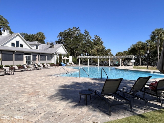 view of swimming pool featuring a pergola and a patio