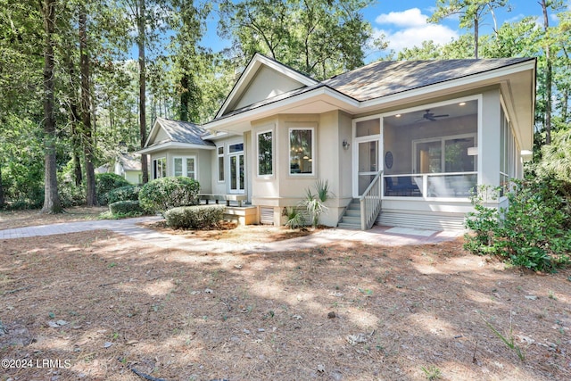 view of front of house with a sunroom and ceiling fan