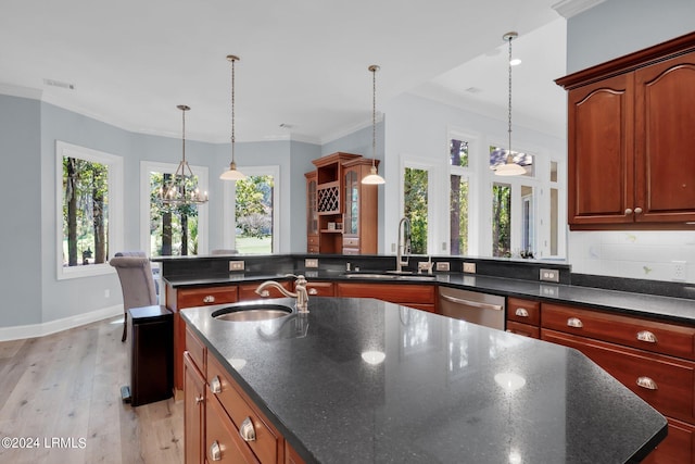 kitchen featuring pendant lighting, sink, light hardwood / wood-style floors, and dishwasher