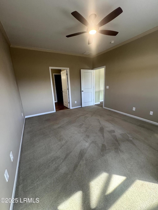 unfurnished bedroom with a ceiling fan, crown molding, baseboards, and carpet floors